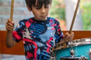 Backbeat Music Academy, Portland OR, a boy plays the drums during a drum lessons