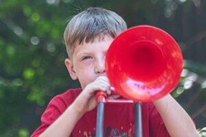 Backbeat Music Academy, portland, OR - a a boy plays the trombone during music lessons at backbeat music academy