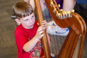 Backbeat Music Academy, portland, OR - a boy playing the harp during music lessons at backbeat music academy