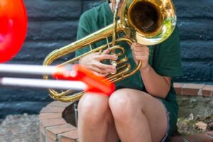 Backbeat Summer Camp Backbeat Music Academy - teen girl playing the trombone at a Try Everything summer camp