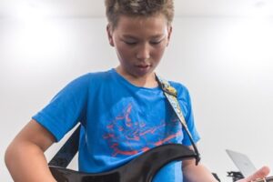 kid playing the guitar at Backbeat Music Academy